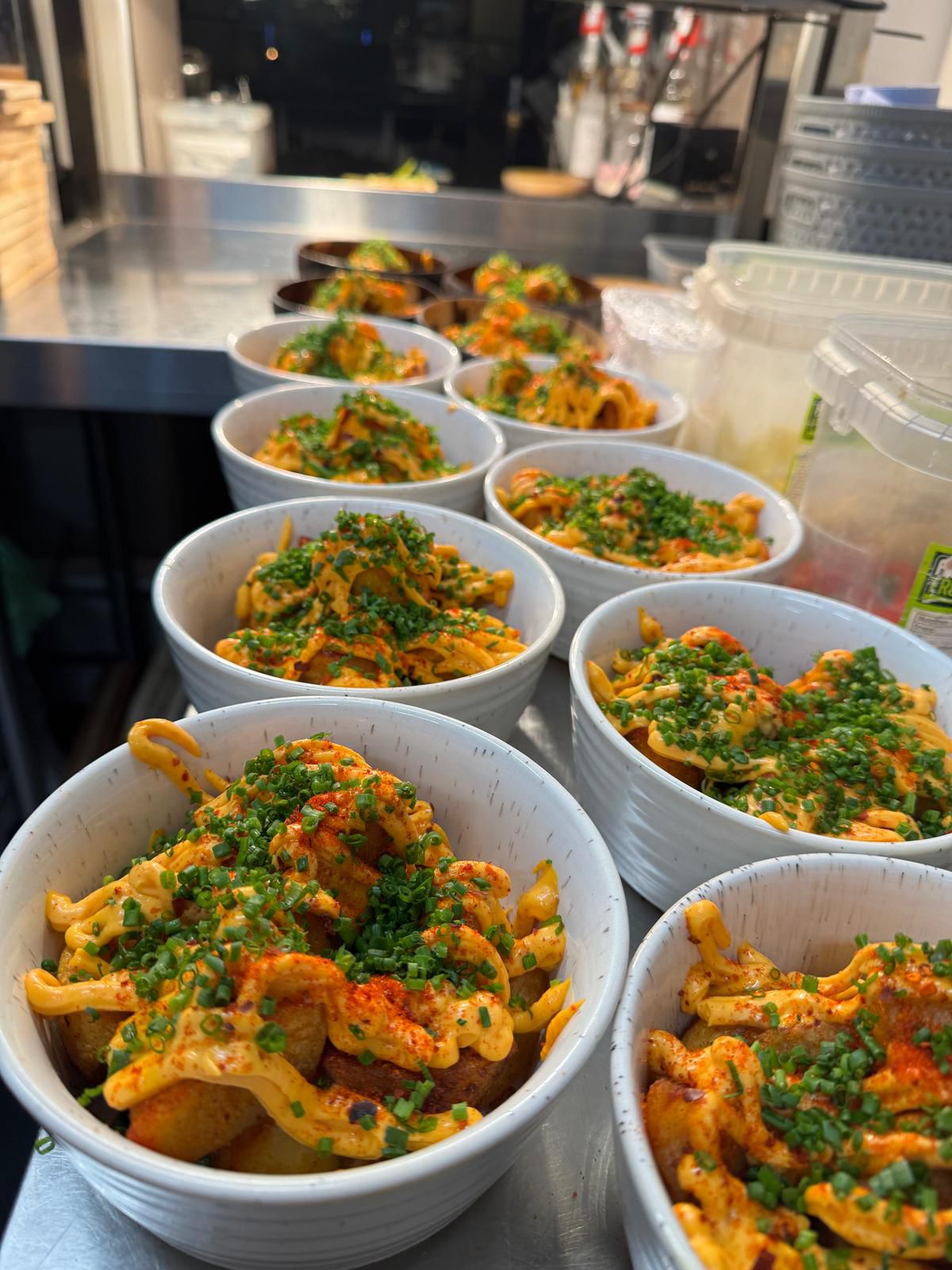 Patatas bravas lined up for service